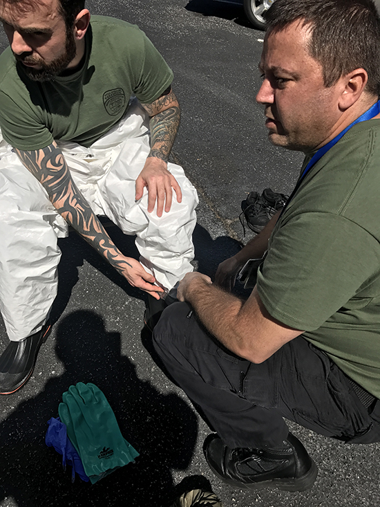 First responders practice suiting up for infectious disease prevention.