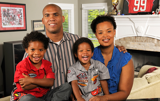 Winning the big game: A stroke took David Jacobs off the football field, but he recovered to have a new career and start a family (shown here with his wife, Desiree, and their two sons).