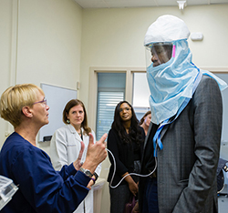 Mutumbo trying on a powered air purifying respirator.