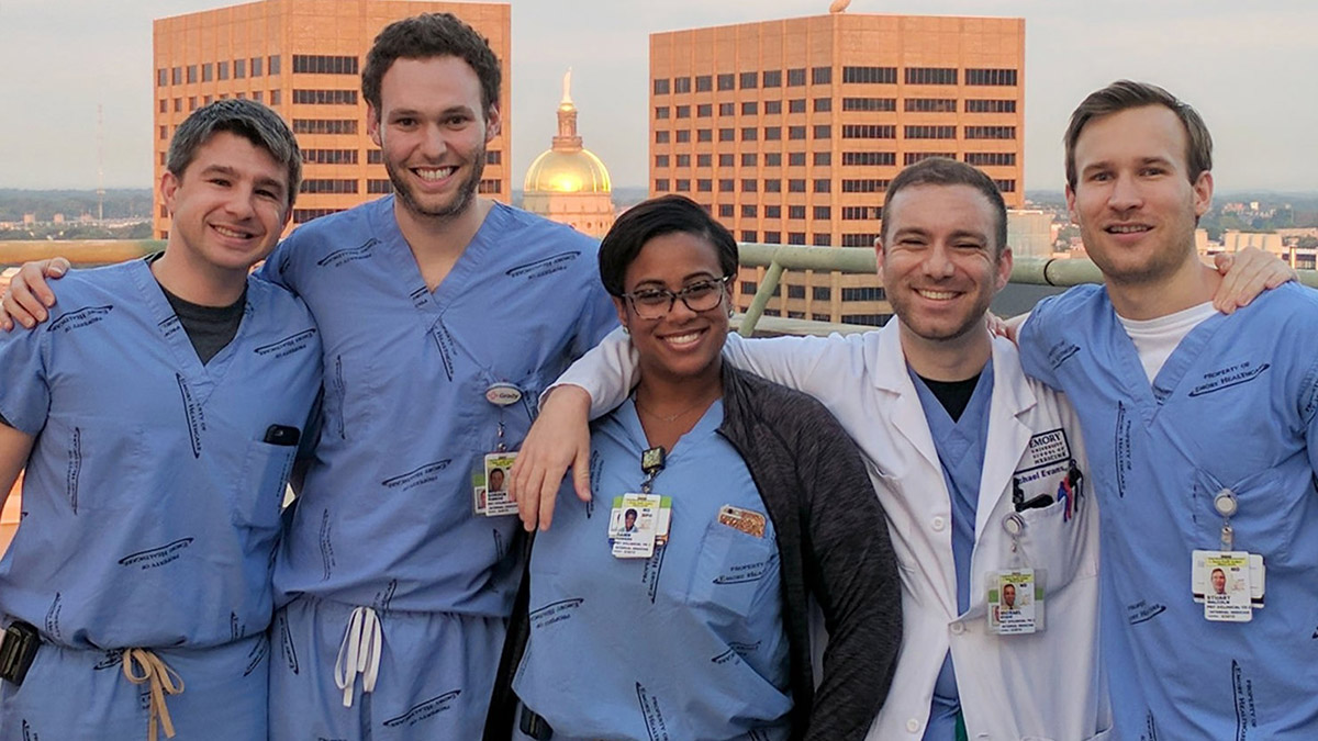 Doctors posing on top of a high hospital building