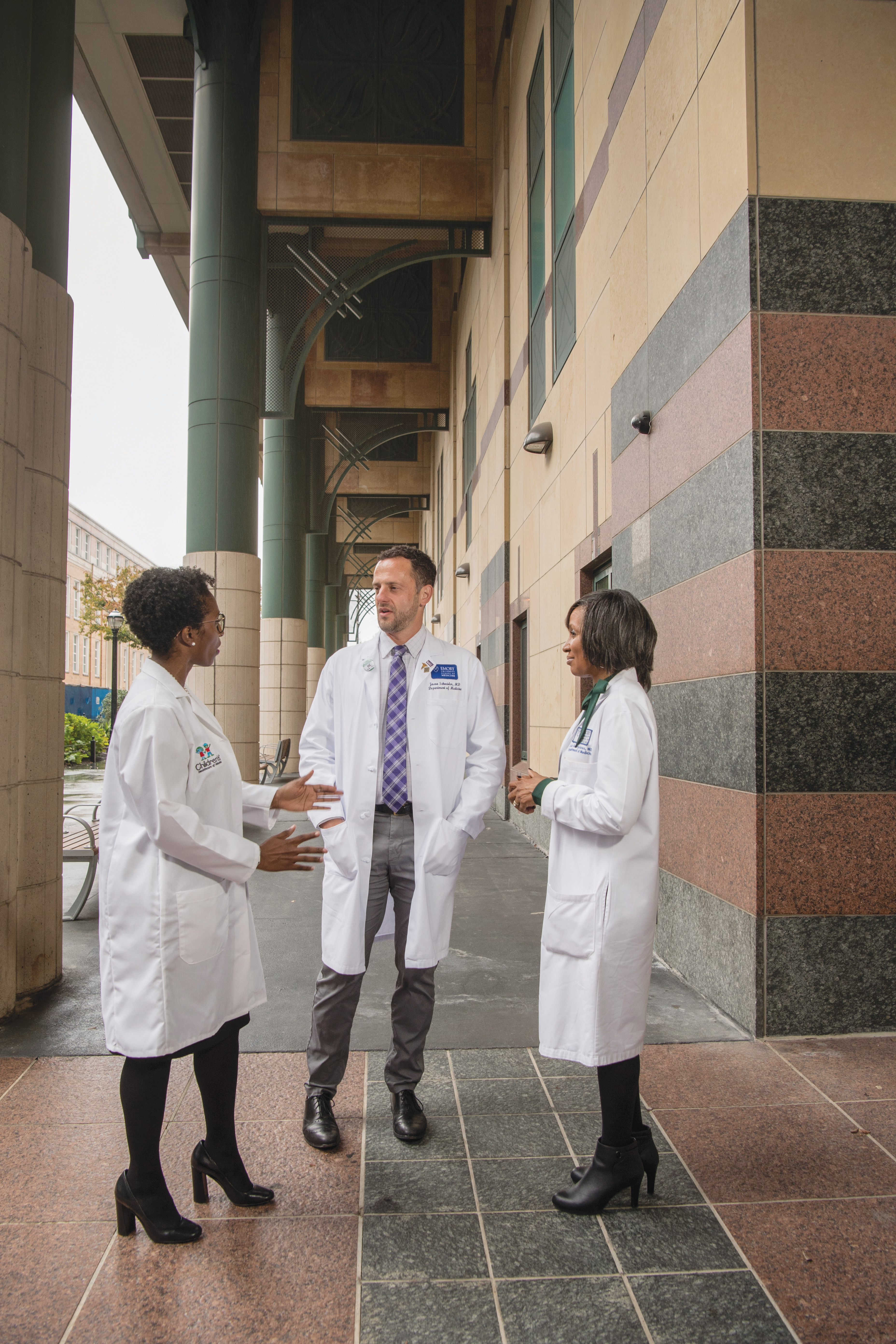 Left to right: Drs. Michelle Wallace, Jason Schneider, and Jada Bussey-Jones talk outside Grady Memorial Hospital in Atlanta.