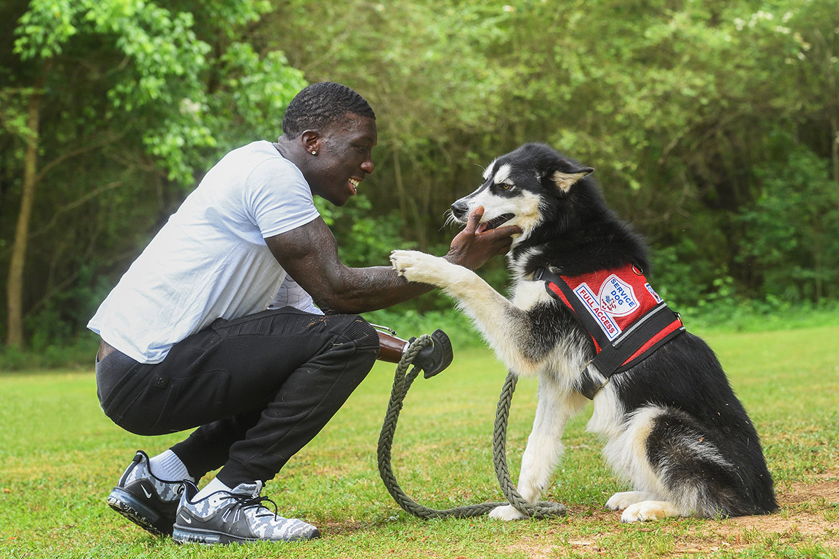 Jalen Richardson with his service dog Shadow